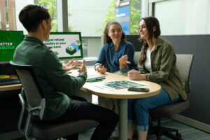 Two women sitting at a desk across from a tax professional.