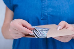 Cash advance being held in a person's hand. 